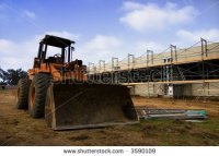 stock-photo-earth-mover-in-front-of-scaffolding-for-a-new-parking-lot-under-construction-3590109.jpg