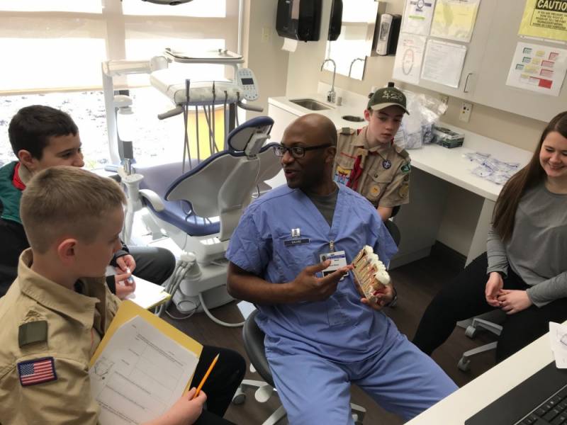 Air Force Capt. Aaron Gause explains the anatomy of teeth and gums to Scouts from local Maryland and northern Virginia. Gause is a resident in the Advanced Education in General Dentistry program at Andrews Air Force Base. (Courtesy photo)