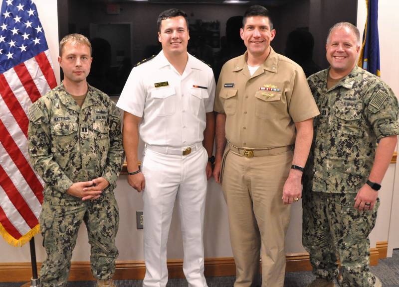 DAHLGREN, Va. (July 17, 2019) - U.S. Naval Academy Midshipman Max Shuman is pictured with the officers he briefed on his Naval Surface Warfare Center Dahlgren Division internship at the command's Laser Lethality and Development Facility which features an above-ground tunnel used for evaluating high energy laser weapon systems. Pictured left to right: Lt. Adam Mattison, Shuman, Cmdr. Steven Perchalski, and Lt. Paul Cross. (U.S. Navy photo/Released)