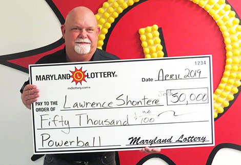 Charles County's Gene Shontere, Jr. collects his $50,000 Powerball prize.