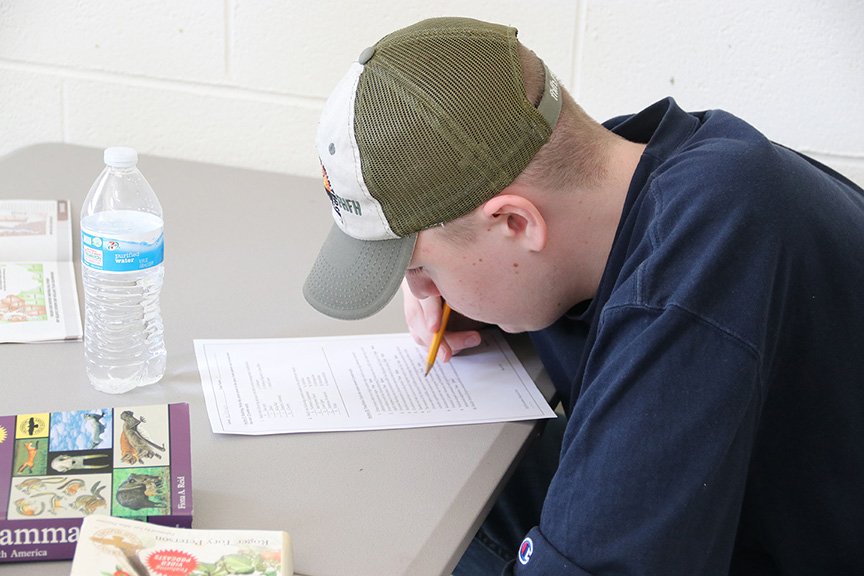 Ryon Price, a sophomore at Maurice J. McDonough High School, looks over a worksheet for the wildlife portion of the Charles County Envirothon.