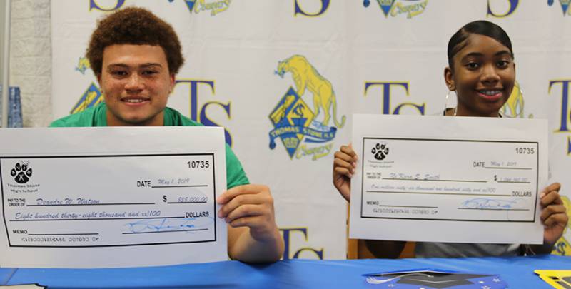 Thomas Stone High School seniors DeAndre Watson, left, and Ne’Kara Smith, are the top male and female scholarship earners in the school’s Advanced Via Individual Determination program. Thomas Stone’s AVID program recently held a signing day ceremony for its college-bound seniors who earned $3.2 million in scholarship offers.