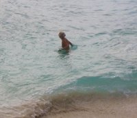 Topless blond swimming.jpg