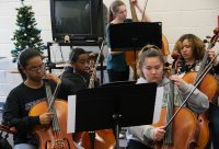 LaShauna Barbour, a Henry E. Lackey High School senior, left, and Sarah Strauss, a junior, participate in a recent strings clinic held at the school.