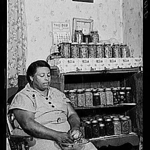 Mrs. Handy with vegetables she has just canned, Aug 1940