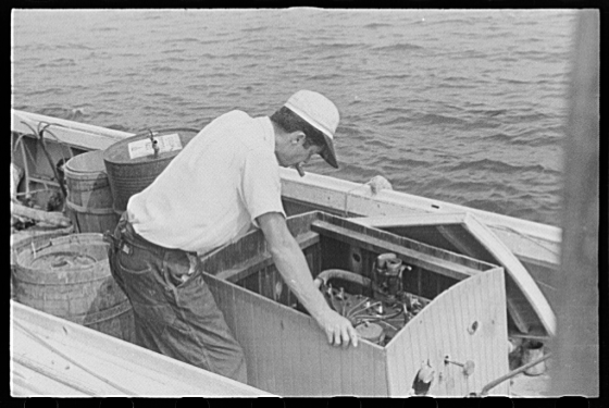 Waterman checking motor before leaving for home. Rock Point, Md 1941